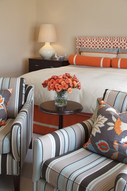 Bedroom with striped armchairs, decorative pillows on chairs. White bedspread and orange accent pillows. contemporary bedroom by Artistic Designs for Living, Tineke Triggs