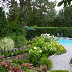 The pool is nestled in a very lush and private garden featuring 