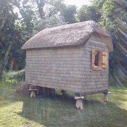 This adorable thatched garden pod would make an ideal outdoor office 