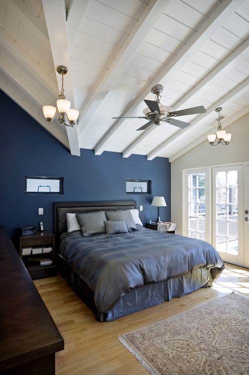 dark blue bedroom is lightened with white ceiling and light wood ...