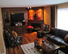 Awkward shaped living room area with a large corner fire place. Looking