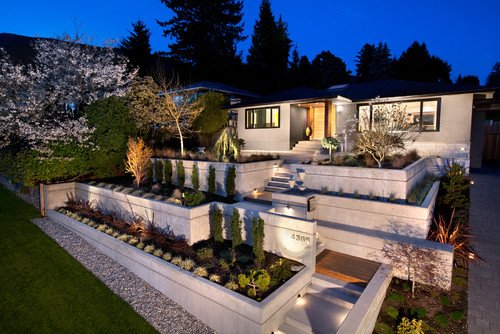 Landscape lighting ideas. Photo credit: Midcentury Exterior by Vancouver Design-Build Firms CCI Renovations