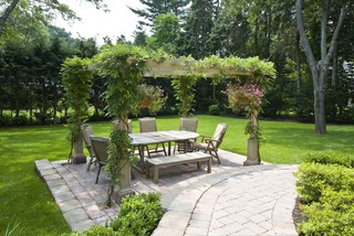 Outdoor dining room with open lattice cover.