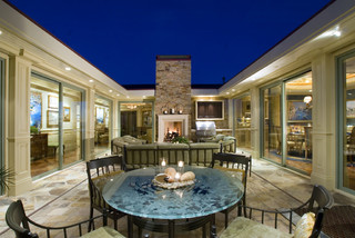 Courtyard with fireplace and dining table.
