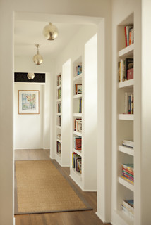hallway with built-in bookshelves