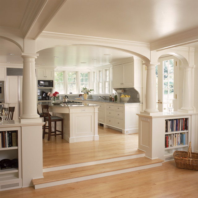 White kitchen and breakfast room with fireplace and arches traditional 