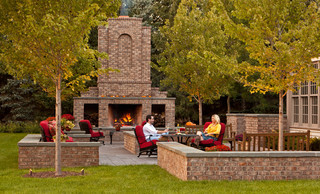 Large, grand outdoor fireplace with integrated seating area.