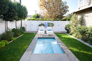 Small wading pool with narrow concrete deck and tiny sunning area.
