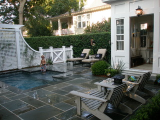 Small rectangular wading pool surrounded by a stone deck.
