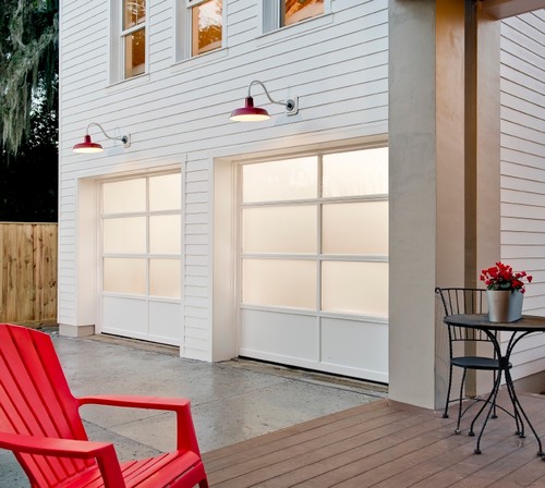 white farmhouse with contemporary garage door
