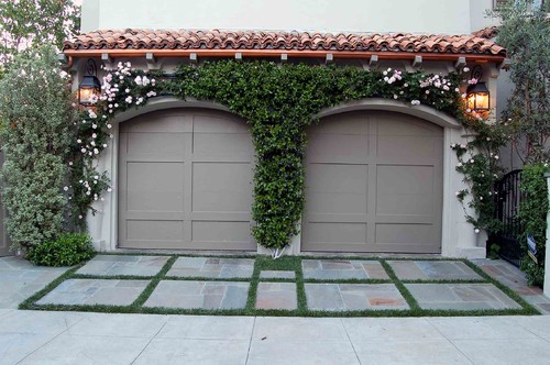 Try some greenary surrounding your garage door.