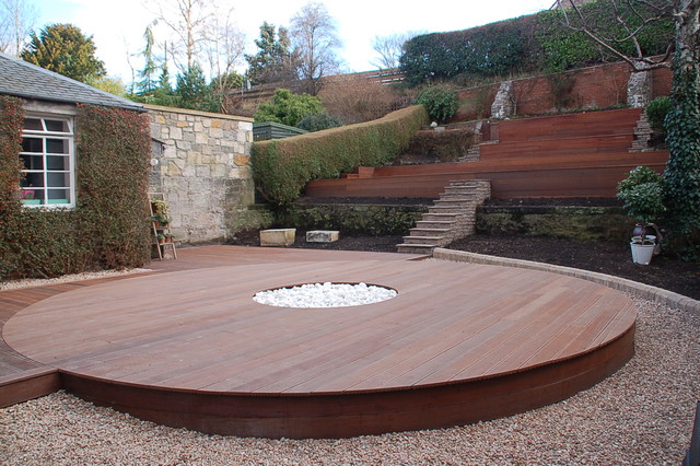 Hardwood deck built to surround a fire pit.