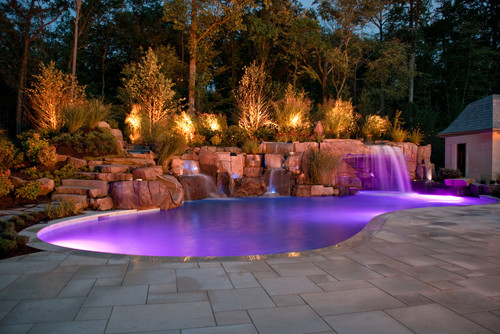 Mediterranean style swimming pool with purple LED lights