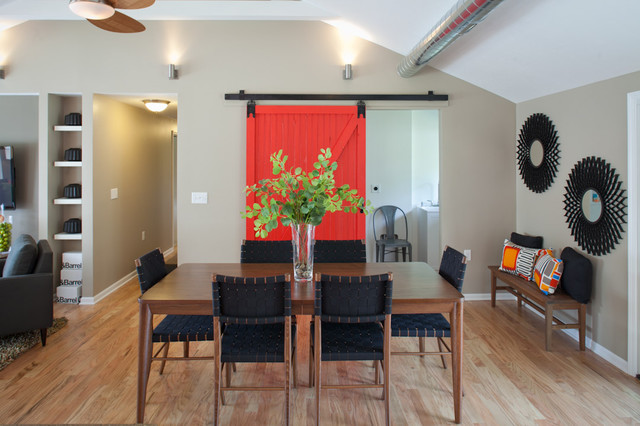 Red barn door with full view of dining table. - transitional 