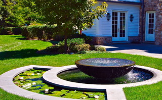 Small round water fountain and small pond in one design.