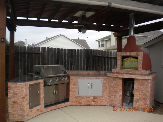 Outdoor kitchen with brick wood fired pizza oven traditional-exterior