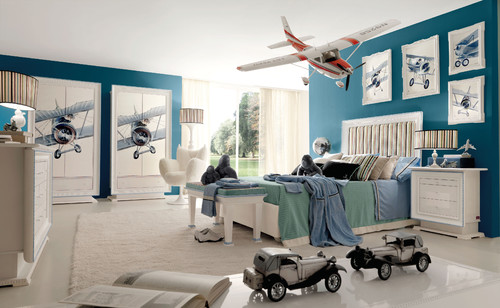 bedroom with airplanes hanging from ceiling