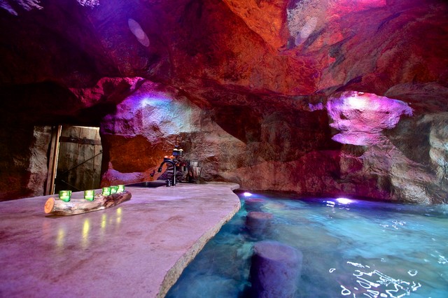 A rustic mine themed pool grotto in oklahoma rustic for Pool design okc