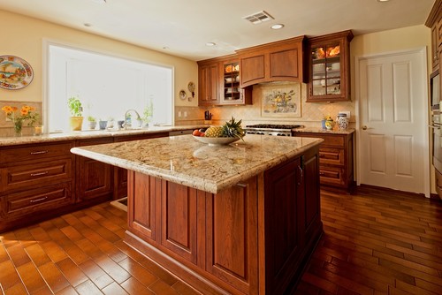 Cherry cabinets match well with granite countertop and backsplash