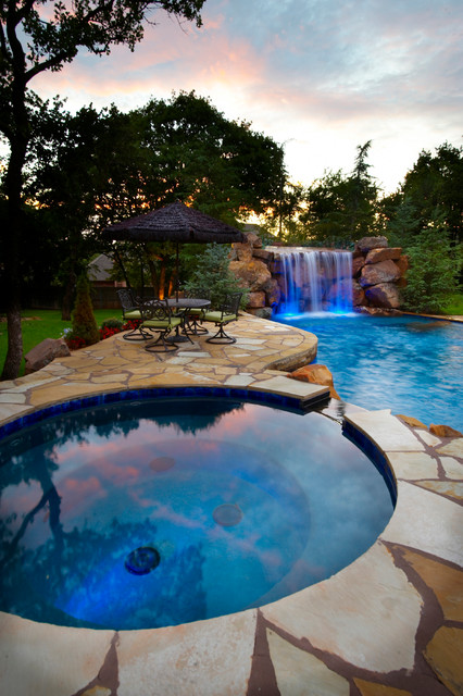 Secluded pool waterfall gives oklahoma home a hidden for Pool design okc