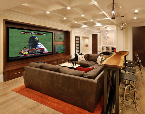 Pendant lights bring big style to this tricked-out sports media room. Photo credit: Traditional Home Theater by San Carlos General Contractors Allwood Construction Inc