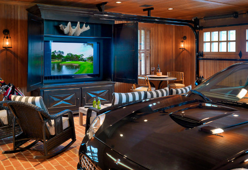 man cave garage with car next to television