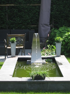 Contemporary small pond with elegant waterfall spout.