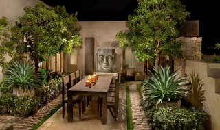 Outdoor dining room with large sculpture.