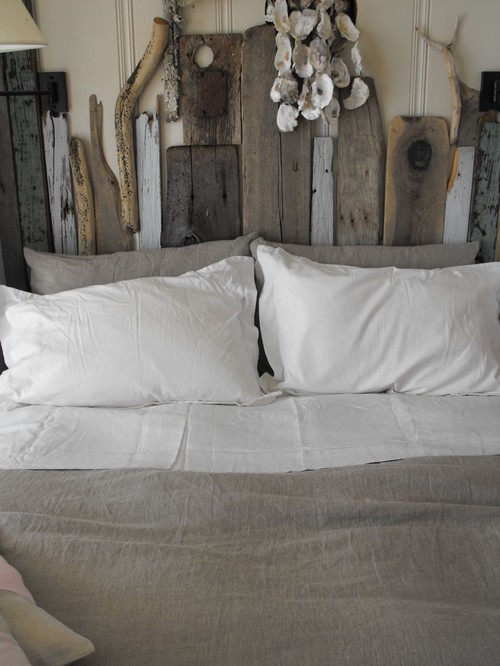 Driftwood and reclaimed wood headboard - what a beautiful focal point in a bedroom and easy DIY!