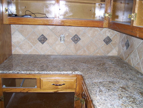 tumbled travertine diagonal backsplash with mediallon inserts