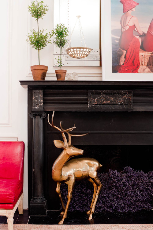 Nomad luxuries photo of a fire place mantel decorated with rustic and modern decor. 