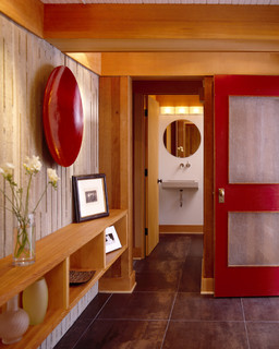 Entry with tile floors, board formed concrete and red door modern entry