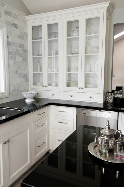 Black-kitchen-counter-white-cabinets-with-silver-cabinet-hardware