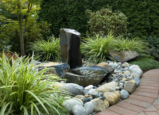 Small natural looking water fountain with lots of rocks.