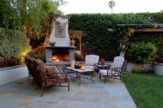 Small outdoor fireplace integrated into planter hardscape.