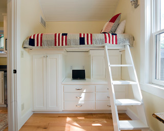 Bed with storage cabinets below.