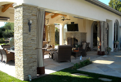 outdoor entertaining can get cozy with curtains to block the wind