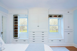 Bedroom wall with built-in cabinets, drawers, and shelves.