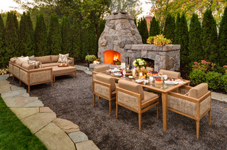 Small outdoor fireplace with seating and dining areas.