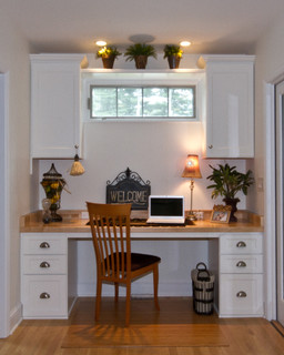 Small home office built at one end of narrow space.
