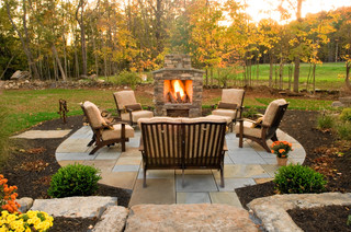 Small outdoor fireplace with round patio in front. (Fall setting.)