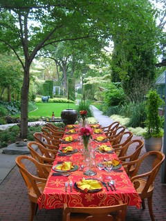 Outdoor dining room with festive table settings for 12.