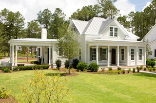 Small house exterior design with columns and porch in front.