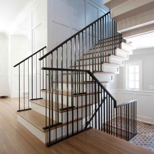 Blackened steel railings. Vertical steel baluster motif. Walnut handrails.