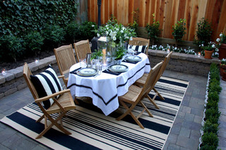 Outdoor dining room with outdoor rug.