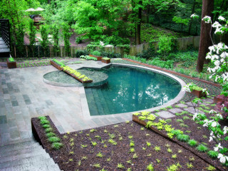 Small half moon wading pool with stone deck.