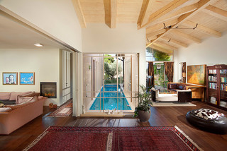 Small lap pool in narrow space surrounded by the house.